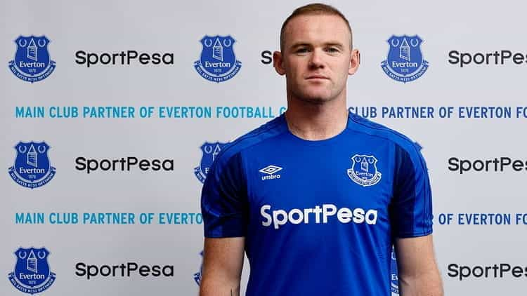 Wayne Rooney wearing a SportPesa sponsored football shirt.