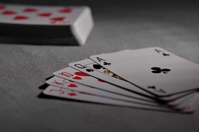 A hand of cards next to a deck of cards.