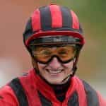 A close-up head shot of jockey, Tom Marquand.